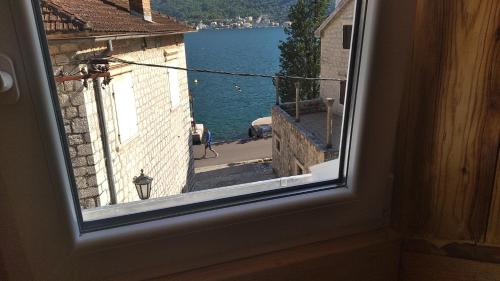 a view from a window of a street and water at Apartment Rosić in Perast