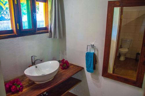 a bathroom with a white sink and a toilet at Vilancool Beach Resort in Vilanculos