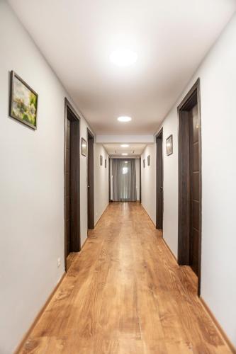 an empty hallway with wood floors and doors at Hotel Tsesi in Tsesi