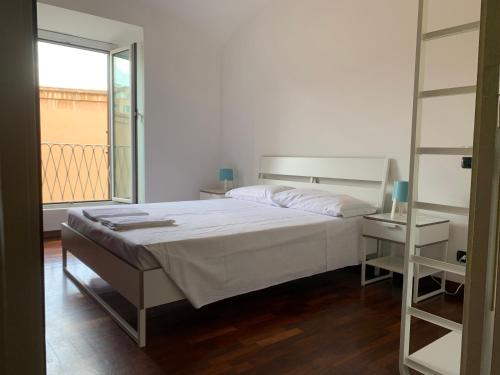 a bedroom with a large bed and a window at Colosseo Boutique Apartment in Rome