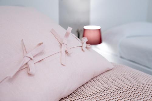 a white bed with two white crosses on it at Ml rooms in Lovere