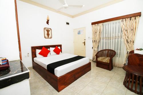 a bedroom with a bed and a desk and a chair at JKAB Park Hotel in Trincomalee