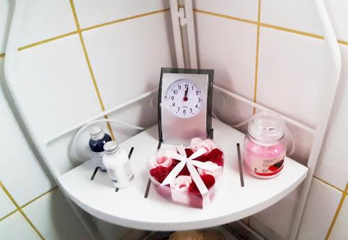 a shelf with a clock and other items on it at Apartman Nino in Tounj