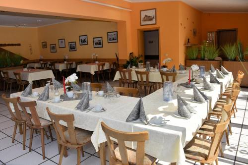 a group of tables with napkins on them in a restaurant at Alt Wehlheiden in Kassel