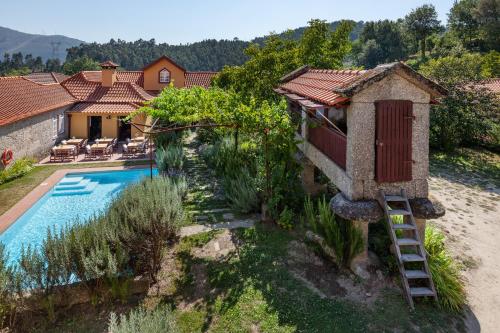an image of a house with a swimming pool at Casa do Eido - sustainable living & nature experiences Gerês in Geres