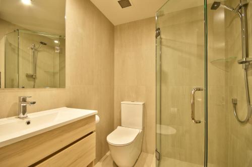 a bathroom with a toilet and a glass shower at Highview Central in Queenstown