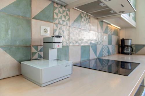 a kitchen with a coffee maker on a counter at Ta Spitakia in Kos Town