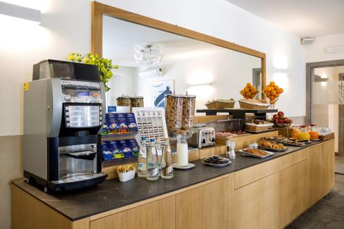 a coffee shop with a counter with food on it at Hotel Baia di Paré in Valmadrera