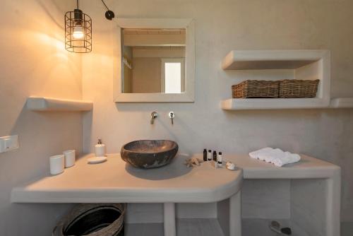 a bathroom with a sink and a mirror at Ta Spitakia in Kos Town