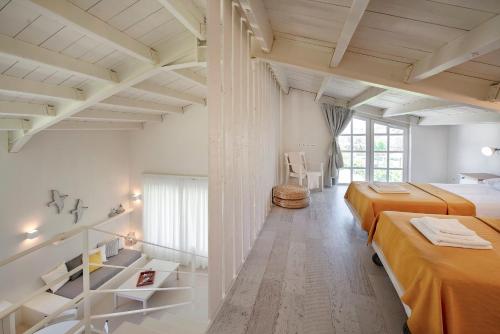 two beds in a room with white walls at Ta Spitakia in Kos Town