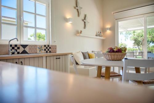 a kitchen with a table with a bowl of fruit on it at Ta Spitakia in Kos Town