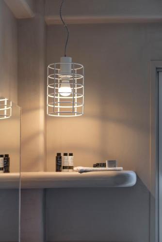 a bathroom with a counter with a light fixture at Ta Spitakia in Kos Town