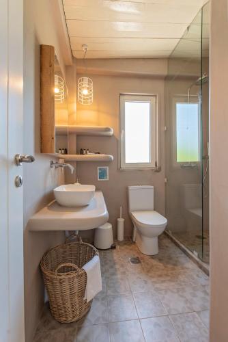 a bathroom with a sink and a toilet at Ta Spitakia in Kos Town