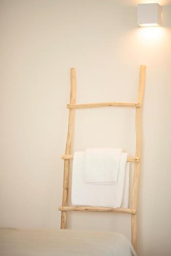 a towel rack on a wall with a white towel at Ta Spitakia in Kos Town