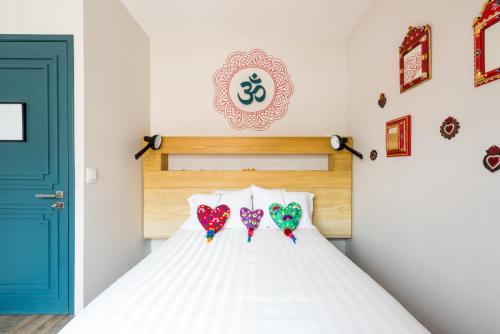 a bedroom with three hearts shaped pillows on a bed at La Palomilla Bed & Breakfast in Mexico City