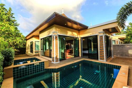 a house with a swimming pool in front of it at Aonang Oscar Pool Villas - Free Shuttle to Aonang Beach -shared pool - private pool in Ao Nang Beach