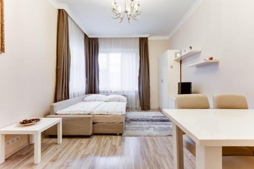 a bedroom with a bed and a couch at Apartment Masná 21 in Prague