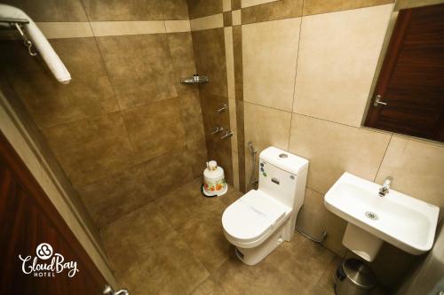 a bathroom with a toilet and a sink at Hotel CloudBay in Kattappana