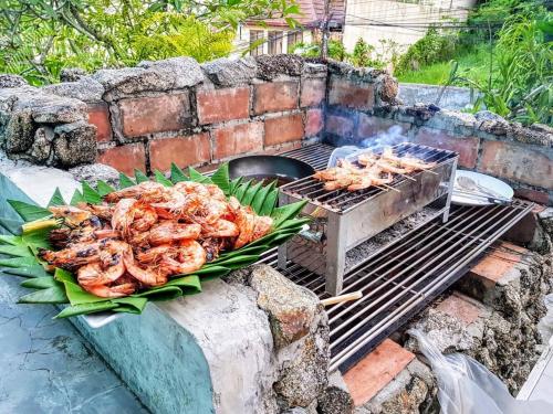 a bunch of shrimp cooking on a grill at Baan Heaven / Patong Beach Pool Villa Sleeps up to 15 in Patong Beach