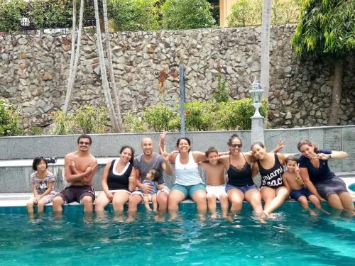 a group of people sitting in a swimming pool at Baan Heaven / Patong Beach Pool Villa Sleeps up to 15 in Patong Beach