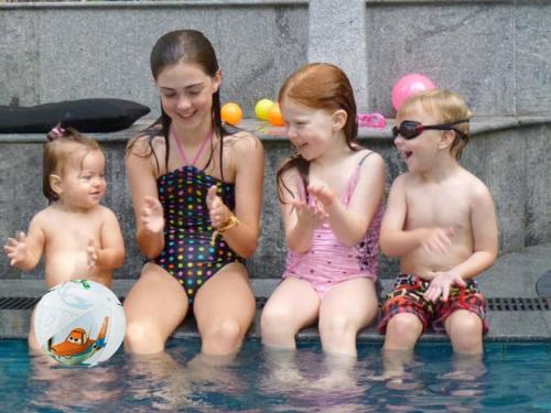 a group of three children sitting in the water at Baan Heaven / Patong Beach Pool Villa Sleeps up to 15 in Patong Beach