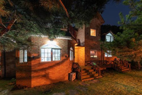 a brick house with a light on the side of it at The Hyu Largo in Yongin
