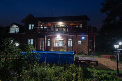 a house with a deck on top of it at night at The Hyu Largo in Yongin