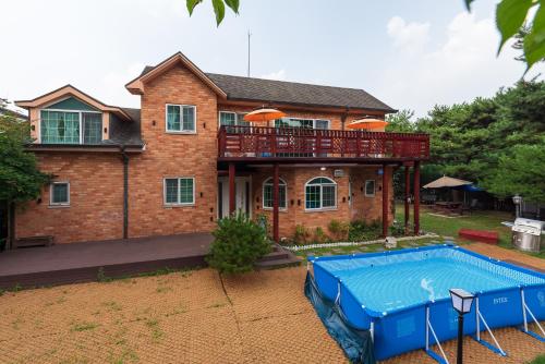 a house with a swimming pool in front of it at The Hyu Largo in Yongin