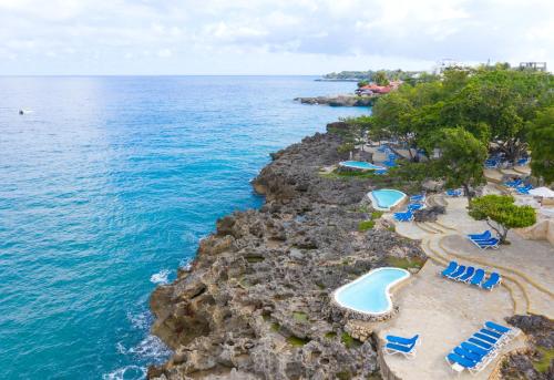 an aerial view of a beach with chairs and the ocean at Casa Marina Beach & Reef All Inclusive in Sosúa