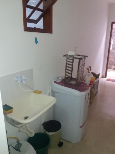 a bathroom with a sink and a toilet in a room at Apartamento 05 Vivendas do Serrano - Lençóis in Lençóis