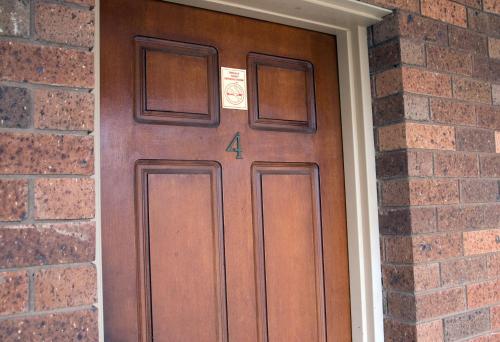 a wooden door with a number four on it at Highway Inn Motel in Hay