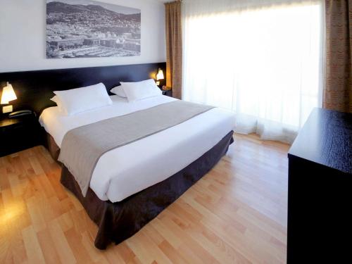 Ένα ή περισσότερα κρεβάτια σε δωμάτιο στο Aparthotel Adagio Nice Promenade des Anglais