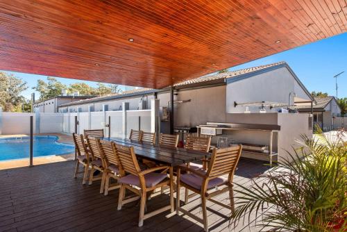 a patio with a table and chairs and a pool at Comfort Inn Moree in Moree