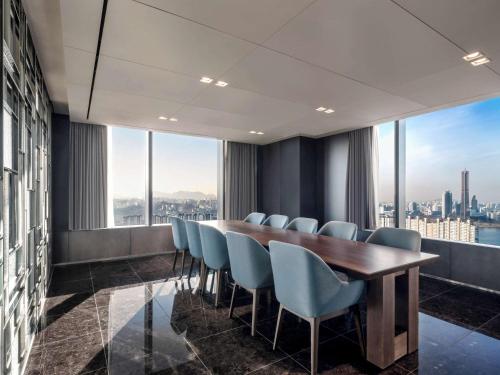 a conference room with a long table and chairs at Novotel Ambassador Seoul Yongsan in Seoul