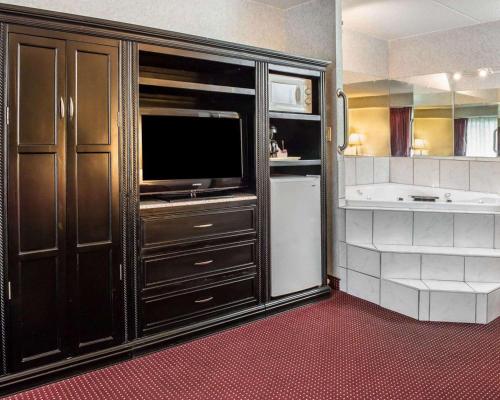 a kitchen with a large entertainment center with a television at Quality Inn & Suites North Gibsonia in Gibsonia