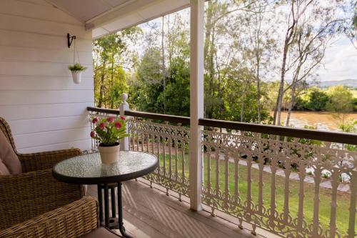 a screened porch with a table and chairs and a window at Bli Bli House Riverside Retreat in Twin Waters