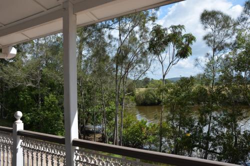 a view of the river from the porch of a house at Bli Bli House Riverside Retreat in Twin Waters