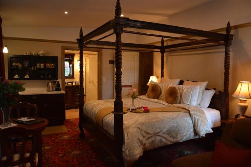 a bedroom with a canopy bed in a room at Bli Bli House Riverside Retreat in Twin Waters