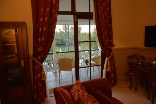 a living room with a couch and a large window at Bli Bli House Riverside Retreat in Twin Waters