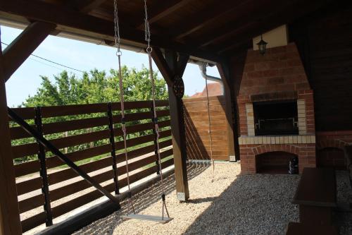 a porch of a house with a fireplace at Ubytovani Valentovi in Velké Bílovice