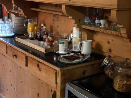 a kitchen with a counter with food on it at Hotel Adler Garni in Zernez