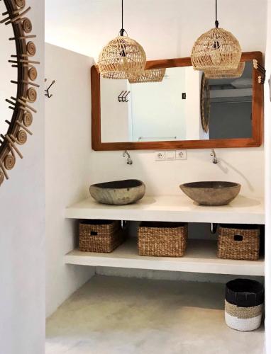 a bathroom with two sinks and a mirror at Mangga Wangga Living in Uluwatu