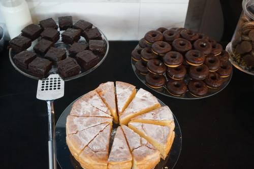 a table with three different types of cakes and chocolatecakes at Hotel White in Krynica Morska