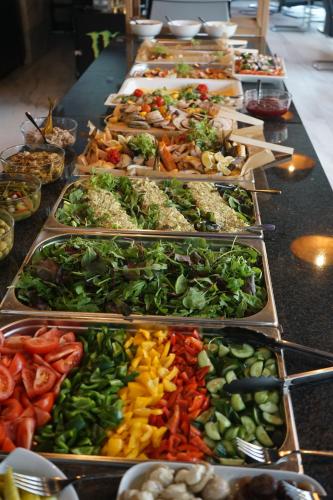 a long buffet of different types of food on a table at Hotel White in Krynica Morska