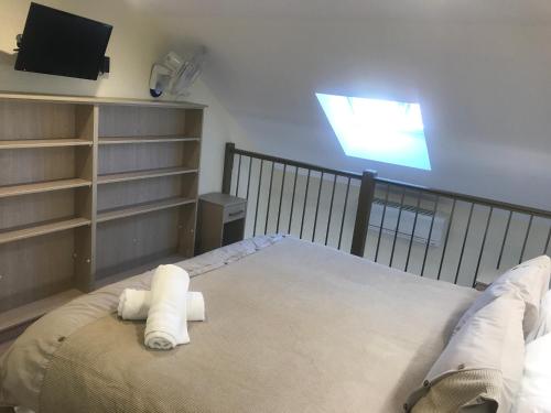 a bedroom with a bed with two towels on it at Randwick City Lodge 2 in Sydney