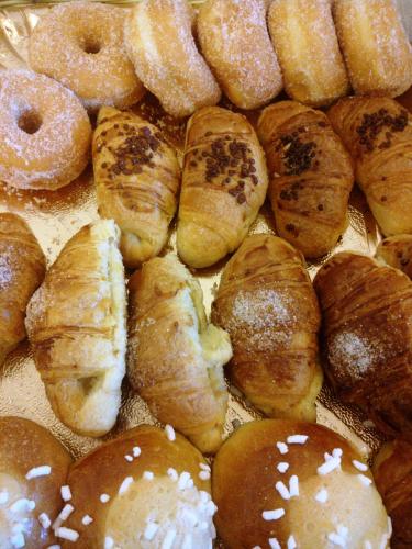a bunch of different types of pastries and donuts at Hotel La Tripergola in Pozzuoli