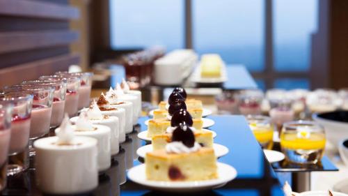 a row of desserts on plates on a table at Lotte City Hotel Jeju Airport in Jeju