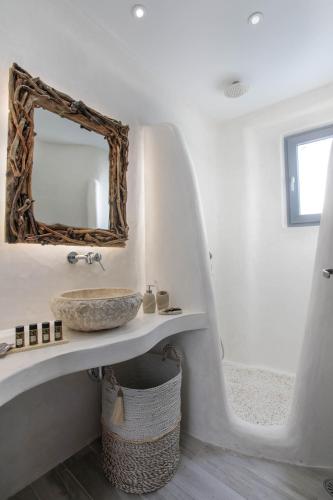 a bathroom with a sink and a mirror at Majestique of Naxos luxury suites in Naxos Chora