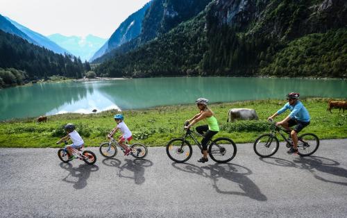 a group of people riding bikes down a road at edelweiss lounge restaurant hotel pizza cafe billard gasthof in Mayrhofen