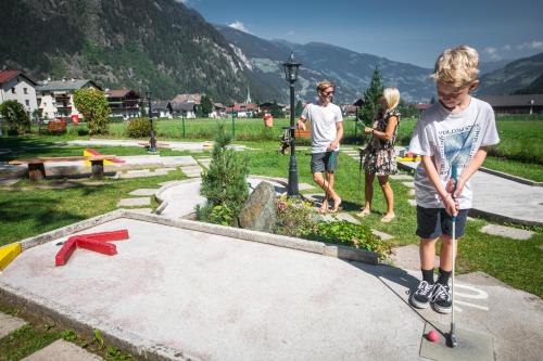 a young boy on a skateboard at a skate park at edelweiss lounge restaurant hotel pizza cafe billard gasthof in Mayrhofen